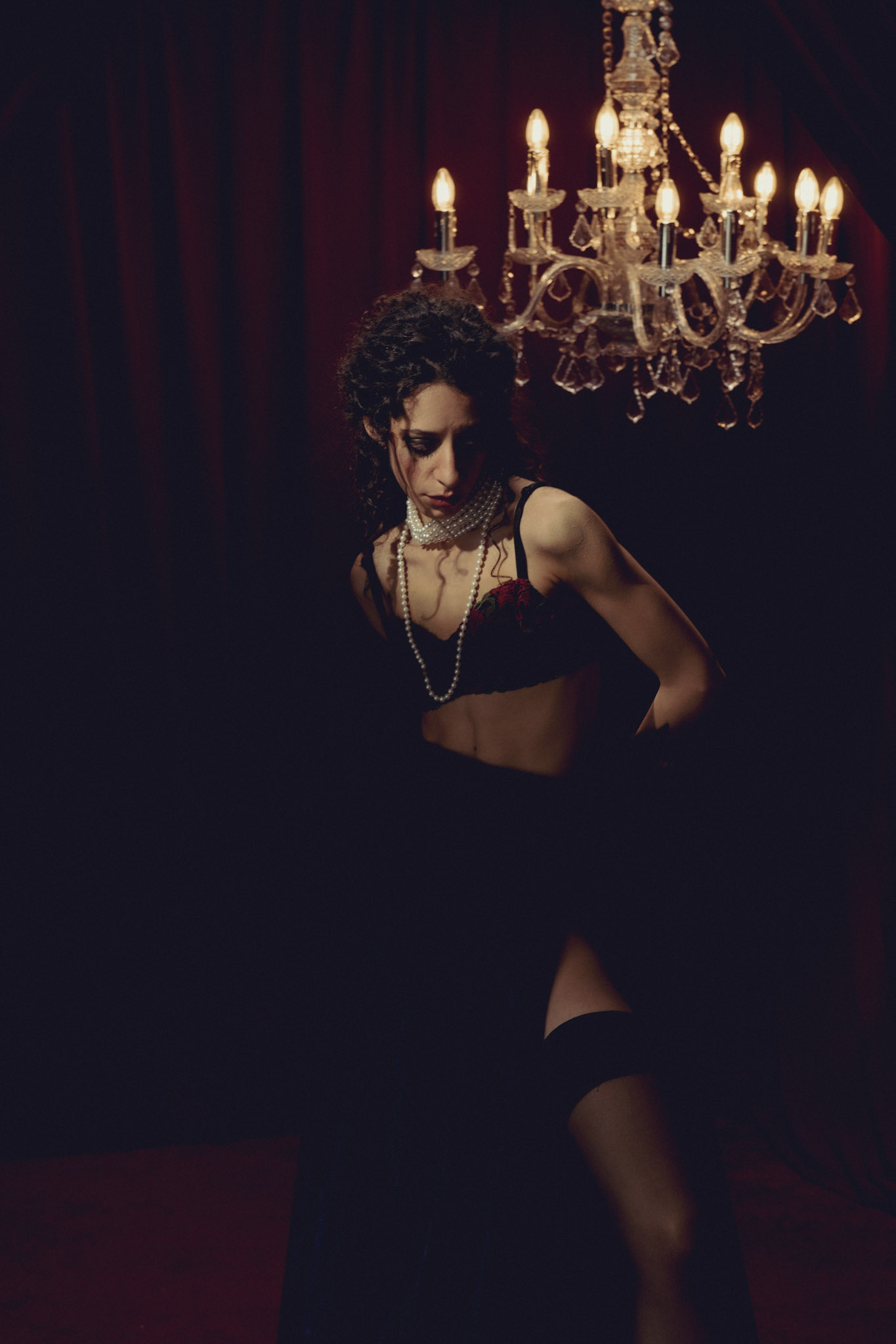 Dark Baroque fashion portrait with theatrical red-room styling